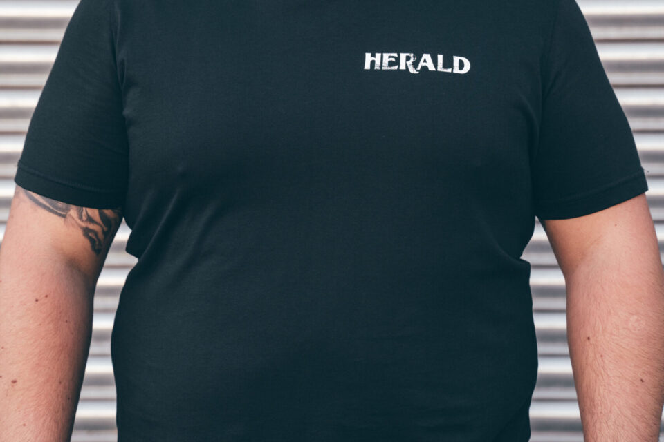 Herald Brand Logo Tee – Black - Image 3